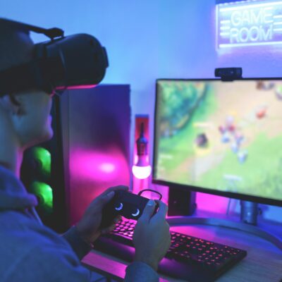 Gamer playing at computer game using joypad