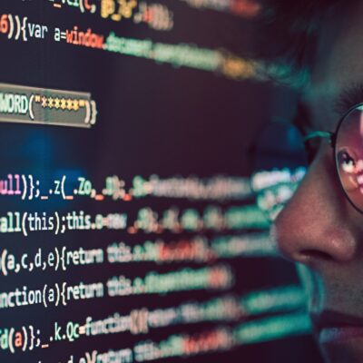 Hacker using computer, smartphone and coding to steal password and private data. Screen with code